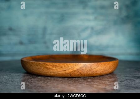 An empty single wooden plate. Stock Photo