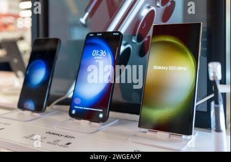 Apple iPhone 14 smartphones models at Apple store. Customers choosing smartphones to purchase. Minsk, Belarus - January 26, 2024 Stock Photo