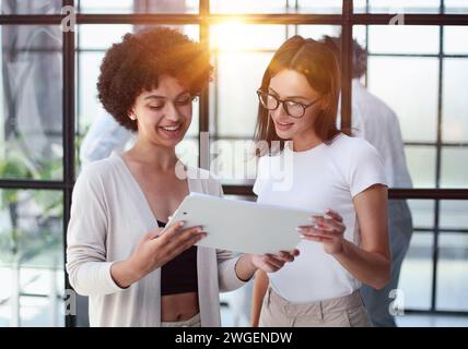 Two women analyzing documents office. Woman executives at work in office discussing some paperwork. Stock Photo