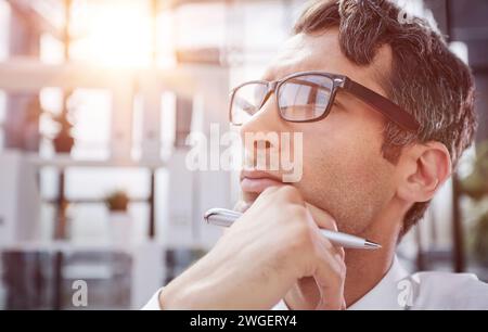 close-up. pensive young businessman in the office looking away. Stock Photo