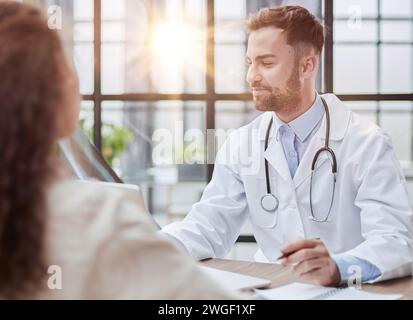 Concentrated male doctor looking at x-ray picture of spine Stock Photo