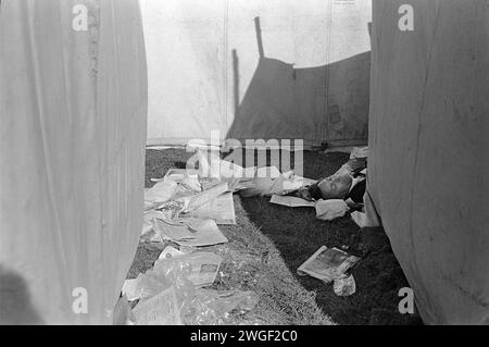 1970s drunk man at the horse races. A day at the races, a man sleeps off a hangover, he's drunk behind the beer tent at the Derby, an annual  festival of horse racing. Epsom Downs, Surrey, England June 1970. HOMER SYKES Stock Photo