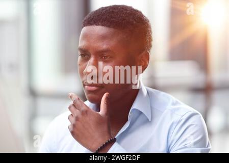 Thoughtful black man in eyeglasses stack with hard task, looking at computer screen, thinking of problem solution Stock Photo