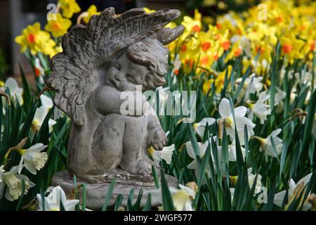 Close-up of a sculpture with spring flowers Stock Photo