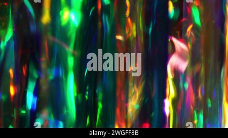 A diamond sparkling with different rainbow neon colors on a dark background. Prism Light Flares Overlay on Black Background Stock Photo