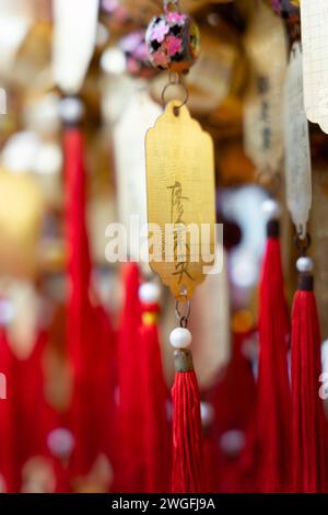 Group of multi-colored paper tags hanging from wall Stock Photo