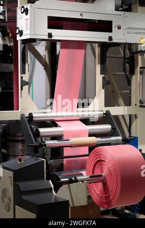 Close up of blown film extruder machine with corona treater system and roll of bag film. Selective focus. Stock Photo