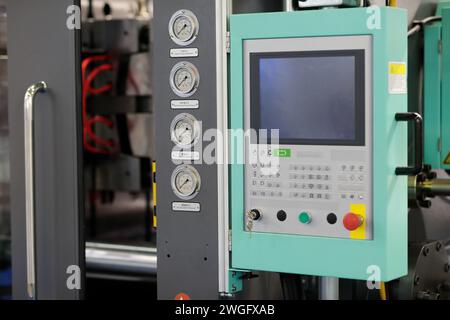 Close up of automatic plastic injection moulding press machine. Selective focus. Stock Photo