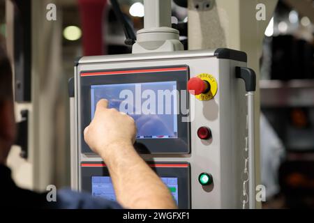 Operator working with touchscreen control panel of industrial machine. Selective focus. Stock Photo