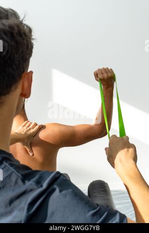 close up of a physiotherapist doing an exercise with an elastic band Stock Photo