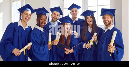 Group portrait of students graduation ceremony, happy young diverse people  Stock Photo
