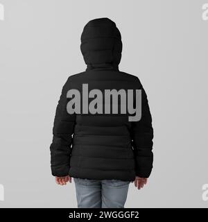 Template black winter kids puffer jacket on girl, warm clothing for cold weather, back view, presentation for design, branding. Mockup of stylish stre Stock Photo