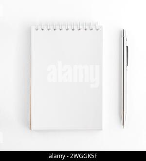 Spiral Notepad with Pen. White notebook and pen Stock Photo
