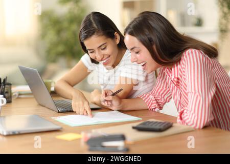 Happy workers checking document policies before sign working at home Stock Photo