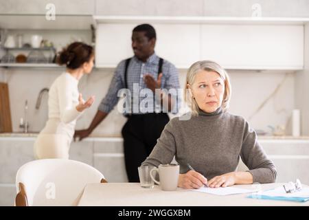Couple discussing testament with elderly woman Stock Photo