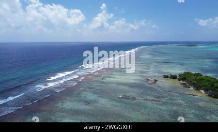 Drone view of paradise islands of the Maldives with coral reefs under the waves of the Indian Ocean Stock Photo