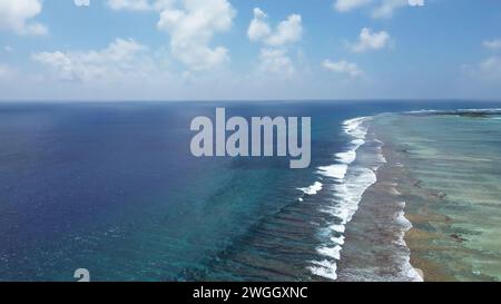 Drone view of paradise islands of the Maldives with coral reefs under the waves of the Indian Ocean Stock Photo