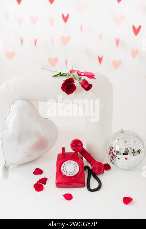 Valentine's Day inspiration of roses, heart shaped props & disco ball Stock Photo