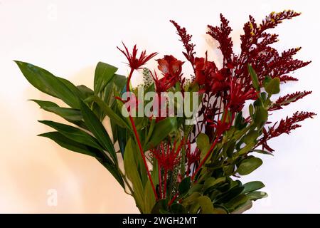 Yellow and red spring bouquet of flowers on a light background. Stock Photo