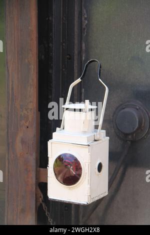 Back of a steam train with a red rail car at the end on a track through ...