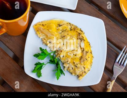 National French dish, omelet made from lightly beaten eggs with milk and herbs Stock Photo