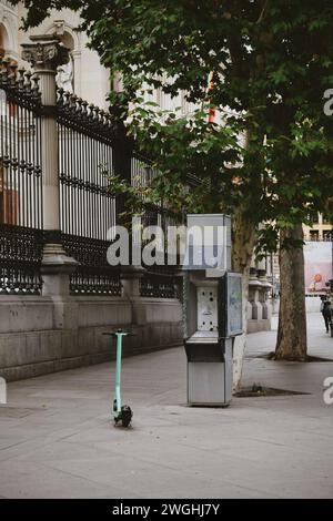 old telephone booth in contrast with electric scooter in Madrid in Spain on September 21, 2021 Stock Photo