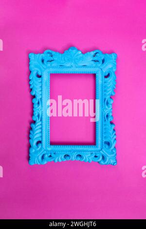 Blue painted baroque frame on magenta background Stock Photo
