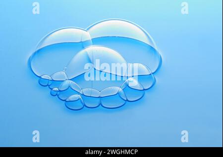 large and small soap bubbles gather on the surface of the water Stock Photo