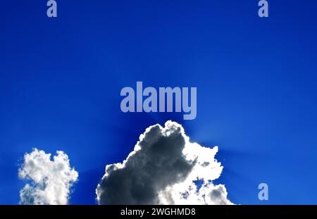 the sun hides behind a spring cloud Stock Photo