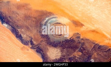 The Richat Structure, or Guelb er Richat, is a prominent circular geological feature in the Adrar Plateau of the Sahara. Stock Photo