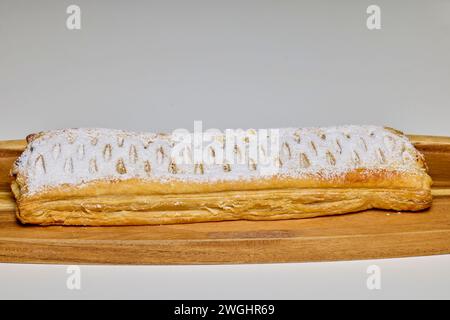 Strudel with sweet cheese and raisins with powdered sugar sprinkled on top, produced at home. Stock Photo