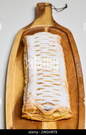 Strudel with sweet cheese and raisins with powdered sugar sprinkled on top, produced at home. Stock Photo