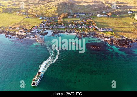 Arial view of the Calmac ferry leaving, Baile Mor on the Isle of Iona as it heads to Fionnphort on Mull in the Inner Hebrides of Scotland Stock Photo