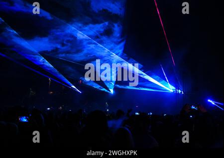 Laser show. Laser lights on the stage during concert. Multicolored light show at night. Abstract background. Laser beam. Stock Photo