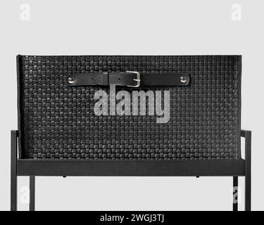 Black leather woven drawer with applied handle on metal shelving unit Stock Photo