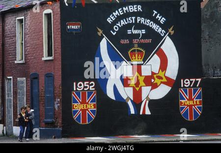 Belfast 1980s. The Troubles. Red Hand Commandos wall painting political mural in Howard Street. Boarded up houses, families moved out of Protestant enclave. Remember the Loyalists Prisoners; 1952-1977 Queens Jubilee. Red Hand Commandos. 1981 UK HOMER SYKES Stock Photo