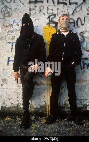 Two young Catholic IRA, 'Hoods'  holding petrol bombs 1980s  The Troubles. They are in the Falls Road, Belfast. ( The Falls Road was the centre of the Catholic urban unrest.) NoRthern Ireland UK 1981. HOMER SYKES Stock Photo