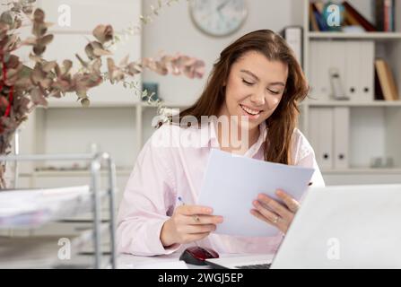 Successful business lady working with documents in modern office Stock Photo