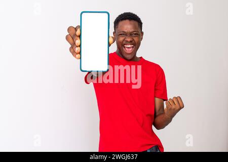 excited young back man shows blank, large phone screen Stock Photo