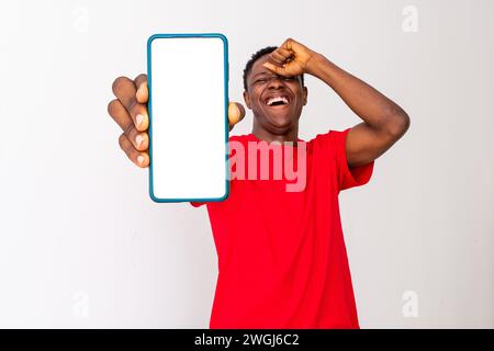 excited young back man shows blank, large phone screen Stock Photo