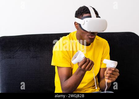 young black man playing games with a virtual reality headset Stock Photo