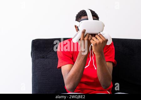 young black man playing games with a virtual reality headset Stock Photo