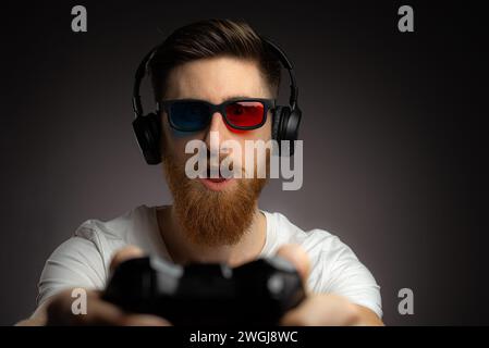 Photo of excited funky man wear t-shirt enjoying playstation game Stock Photo