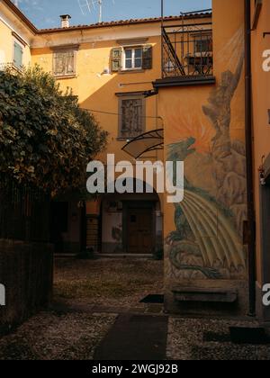 cozy old street in Sulzano with painting on the wall, lake Iseo, Italy Stock Photo