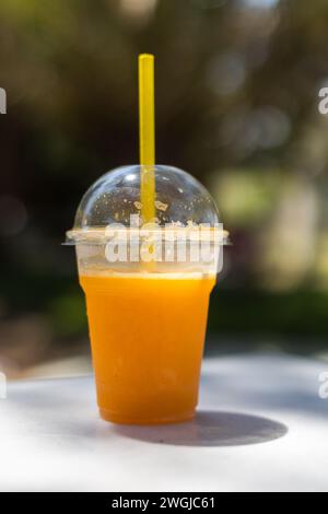 fresh orange juice in closed plastic cup Stock Photo