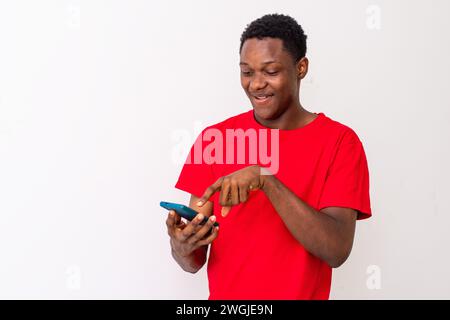 smiling young black man checking his smartphone Stock Photo
