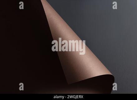 Abstract background with brown curled sheet of paper on a gray wall. Copy space. Stock Photo