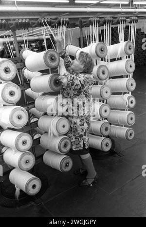 Woman factory work, textile industry Salts Mill, lady working on the factory floor 1980s UK. Cotton textiles factory Saltaire, Near Bradford, West Yorkshire England 1981. UK HOMER SYKES Stock Photo