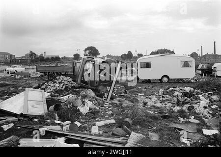 A gypsy Irish travellers encampment and temporary scrap car dump on waste ground in Balsall Heath, an inner city slum  area. Balsall Heath, Birmingham, England March 1968 1960s UK HOMER SYKES Stock Photo