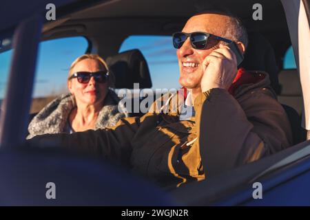 Smiling senior couple driving car. Stock Photo